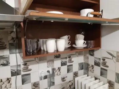 a shelf with cups and dishes on it in a kitchen at Max Apartament okolice Energylandia Zator in Oświęcim