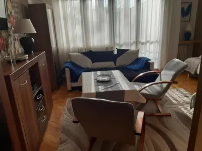 a living room with a couch and a table and chairs at Max Apartament okolice Energylandia Zator in Oświęcim