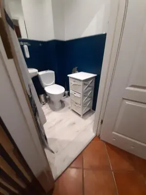 a bathroom with two toilets and a sink and a door at Max Apartament okolice Energylandia Zator in Oświęcim