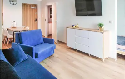 a living room with a blue couch and a table at 1 Bedroom Amazing Apartment In Zator in Zator