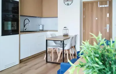 a kitchen with a table and chairs in a room at 1 Bedroom Amazing Apartment In Zator in Zator