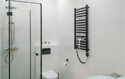 a bathroom with a shower and a phone on the wall at 1 Bedroom Amazing Apartment In Zator in Zator