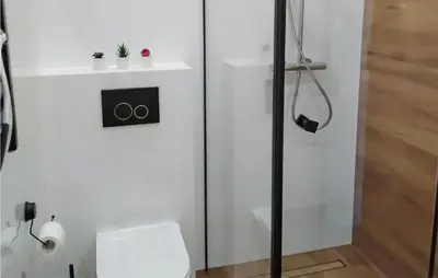 a white bathroom with a shower and a toilet at 1 Bedroom Amazing Apartment In Zator in Zator