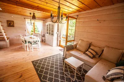 a living room with a couch and a table at Dom na Wielkiej Polanie in Sidzina