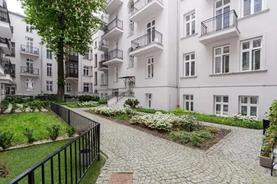 a walkway in front of a white building at Malila Premium Apartments Cracow Centre Starowiślna 41 in Kraków