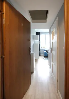 a hallway with a wooden door in a room at Aleja Słowackiego 18 by Homeprime in Kraków
