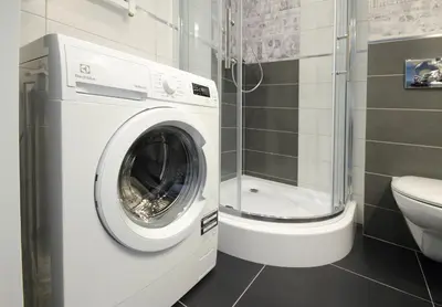 a washing machine in a bathroom with a toilet at Aleja Słowackiego 18 by Homeprime in Kraków
