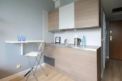 a kitchen with a counter and a chair in it at Aleja Słowackiego 18 by Homeprime in Kraków