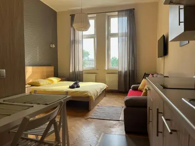 a small room with a bed and a couch at Cheerful Corner in Kraków