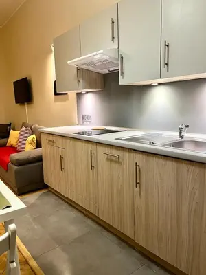 a bedroom with a bed and a couch and lights at Cheerful Corner in Kraków
