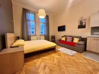 a bed with two purple towels laying on it at Cheerful Corner in Kraków