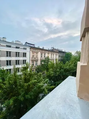 a bedroom with a large bed and a bathroom at Cheerful Corner in Kraków
