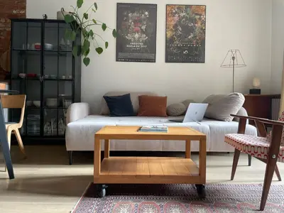 a living room with a couch and a coffee table at Elegant Riverside Flat Garden in Kraków