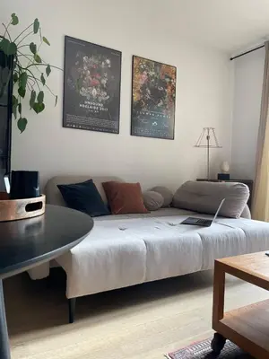 a living room with a couch and a table at Elegant Riverside Flat Garden in Kraków