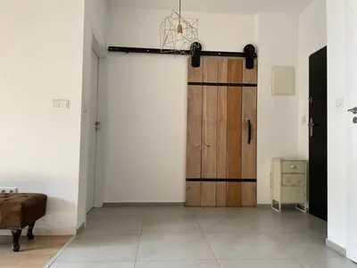 a room with a wooden door and a table at Elegant Riverside Flat Garden in Kraków