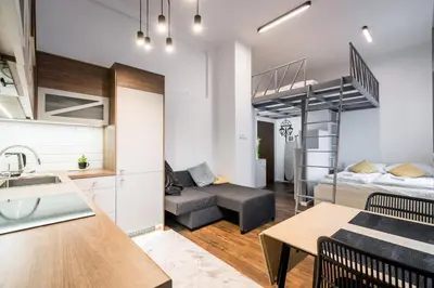 a kitchen and a living room with a bunk bed at Old Railway Station view Lubicz Residence WAWELOFTS in Kraków