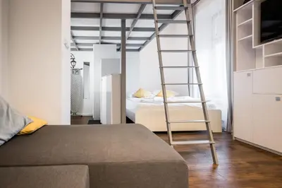 a ladder in a bedroom with a bunk bed at Old Railway Station view Lubicz Residence WAWELOFTS in Kraków