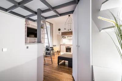 a kitchen and living room with a dark ceiling at Old Railway Station view Lubicz Residence WAWELOFTS in Kraków