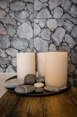 two candles sitting on a table with rocks at Old Railway Station view Lubicz Residence WAWELOFTS in Kraków