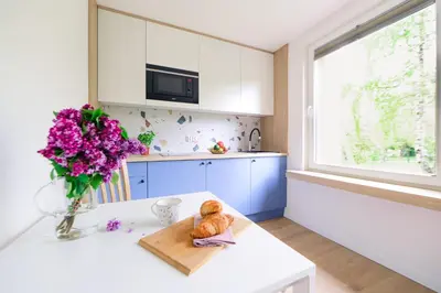 a kitchen with a table with a vase of flowers at Telimeny 31 in Kraków