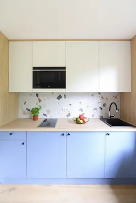 a kitchen with white cabinets and a microwave at Telimeny 31 in Kraków
