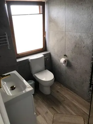 a bathroom with a toilet and a sink and a window at Noclegi DobraNocka in Sąspów