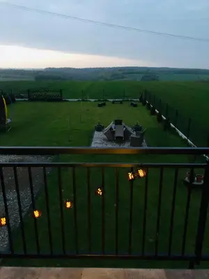 a view from a balcony of a park with lights at Noclegi DobraNocka in Sąspów