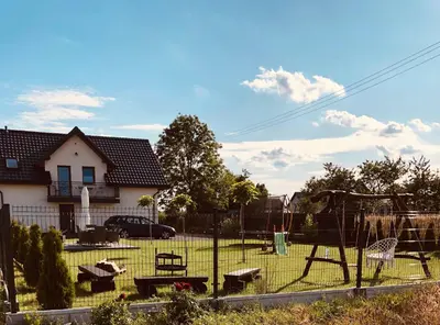 a playground with a swing set in a yard at Noclegi DobraNocka in Sąspów