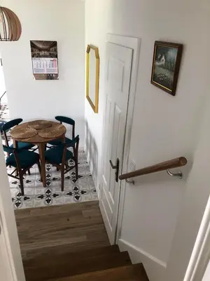a hallway with a table and chairs next to a door at Noclegi DobraNocka in Sąspów