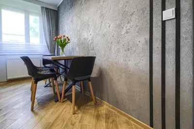 a dining room with a table and chairs at Apart Dwudziestolecie in Wadowice