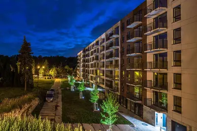 an apartment building with christmas trees in front of it at Nowy apartament - Bulwary nad Sołą - 52m2 in Oświęcim