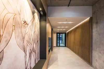 a hallway with a mural of flowers on the wall at Nowy apartament - Bulwary nad Sołą - 52m2 in Oświęcim