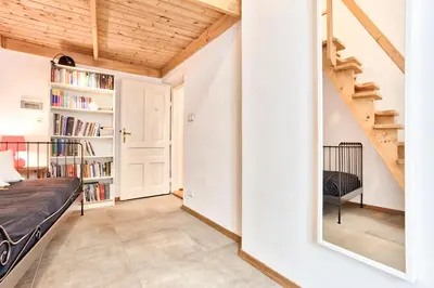 a bedroom with a bed and a book shelf at Zacisze Street in Kraków