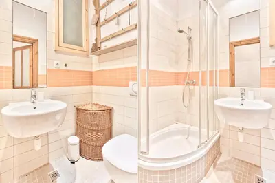 a bathroom with a shower and a sink and a toilet at Zacisze Street in Kraków