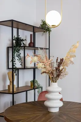 a table with a white vase with flowers on it at Old Town Długa 48 Family Apartment by Noclegi Renters in Kraków