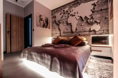 a bedroom with a map of the world on the wall at EXCLUSIVE APARTMENTS ZATOR in Zator