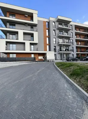 an empty parking lot in front of a building at EXCLUSIVE APARTMENTS ZATOR in Zator