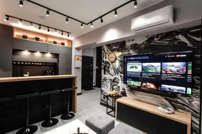 a bar with a large screen in a room at EXCLUSIVE APARTMENTS ZATOR in Zator