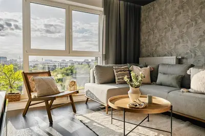 a living room with a couch and a table at Vermelo Boho Apartment in Kraków