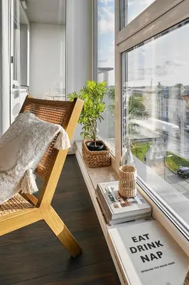 a room with a chair in front of a window at Vermelo Boho Apartment in Kraków