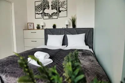 a bedroom with a bed with white pillows at Just 5 by Housine in Zator
