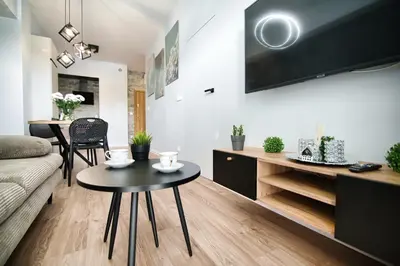a living room with a couch and a table at Just 5 by Housine in Zator