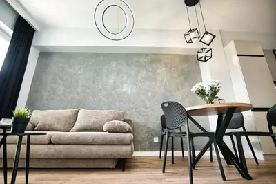a living room with a couch and a table and chairs at Just 5 by Housine in Zator