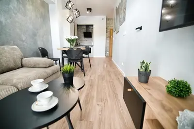 a living room with a couch and a table at Just 5 by Housine in Zator