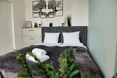 a bedroom with a bed with white pillows at Just 5 by Housine in Zator