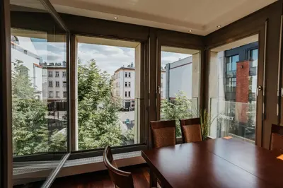 a dining room with a table and a large window at Plac Nowy Panorama Old Town View on Kazimierz in Kraków