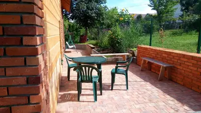 a patio with a table and chairs and a bench at Cztery Pory Roku pokoje z łazienkami do wynajęcia in Osiek