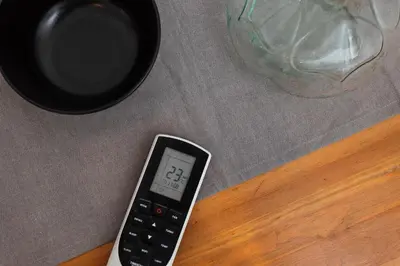a remote control sitting on top of a table at City of the Kings-Camomile Apartment in Kraków