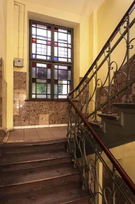 a staircase in an old building with a window at City of the Kings-Camomile Apartment in Kraków