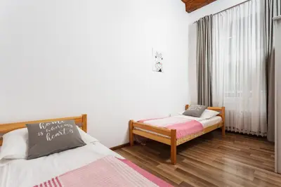 a bedroom with two beds and a window at City of the Kings-Camomile Apartment in Kraków